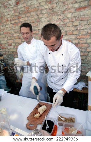 KIEV, UKRAINE - OCTOBER 11, 2014: Unidentified people cook and trades creative dishes of molecular cuisine on food stall in Street Food Festival in Kiev, Ukraine.
