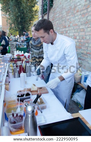 KIEV, UKRAINE - OCTOBER 11, 2014: Unidentified people cook and trades creative dishes of molecular cuisine on food stall in Street Food Festival in Kiev, Ukraine.