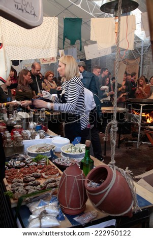 KIEV, UKRAINE - OCTOBER 11, 2014: Unidentified people cook and trades traditional dishes of Odessa restaurant on food stall in Street Food Festival in Kiev, Ukraine.