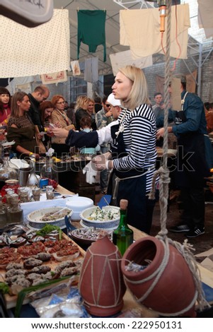 KIEV, UKRAINE - OCTOBER 11, 2014: Unidentified people cook and trades traditional dishes of Odessa restaurant on food stall in Street Food Festival in Kiev, Ukraine.