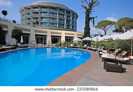 BELEK, TURKEY - AUGUST 10, 2008: Summer view of Calista Luxury Resort Hotel & Spa with swimming pool, sun beds and contemporary round building in Belek, Turkey.