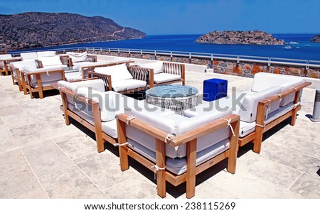 ELOUNDA, GREECE - JULY 13, 2012: Terrace sea view with outdoor lounge furniture in a luxury resort Elounda, Crete, Greece.