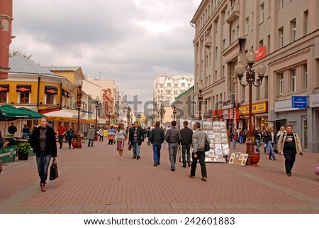 MOSCOW, RUSSIA - MAY 15, 2011:Locals and tourists walking on famous pedestrian Arbat Street in Moscow,Russia. Street artists are showing and selling their pictures to the tourists on street market.