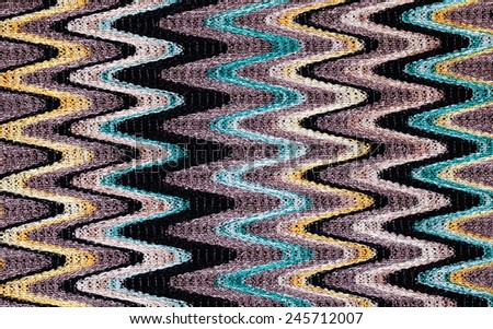 Blue, yellow and grey waves vertical lines pattern fabric closeup background, toned image