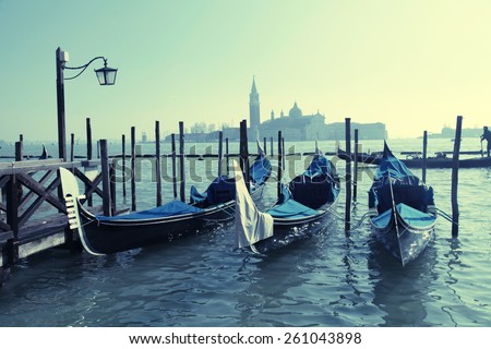 Gondolas moored by Saint Mark square with San Giorgio di Maggiore church in the background - Venice, Venezia, Italy