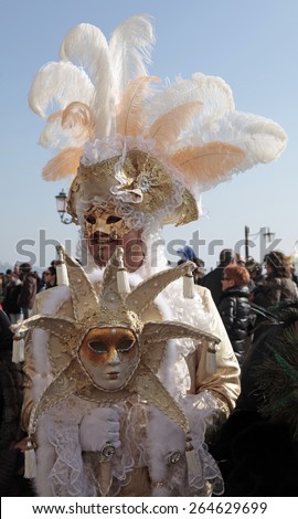 VENICE, ITALY - FEBRUARY 8, 2015: Unidentified masked man in costume on San Marco Square during the Carnival in Venice, Italy.