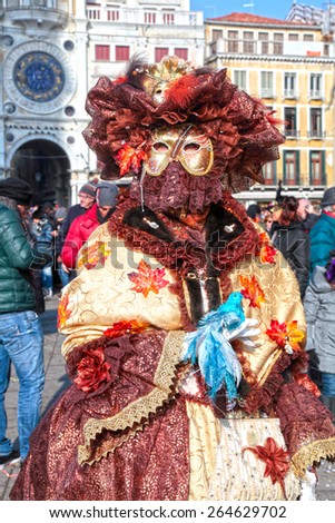 VENICE, ITALY - FEBRUARY 8, 2015: Unidentified masked woman in costume on San Marco Square during the Carnival in Venice, Italy.