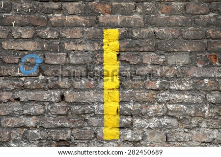 old grunge grey brick wall texture background with yellow painting line