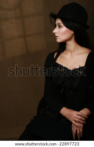 Classical woman portrait in hat sepia colors