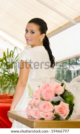 Young bride Girl and roses in cafe