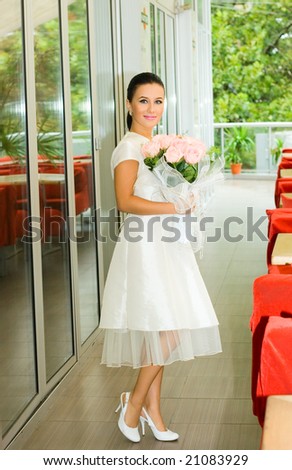 Pretty bride girl with roses in cafe