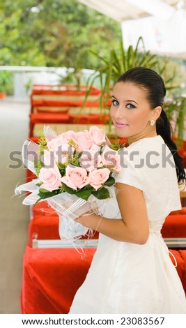 Pretty bride girl with flowers in cafe