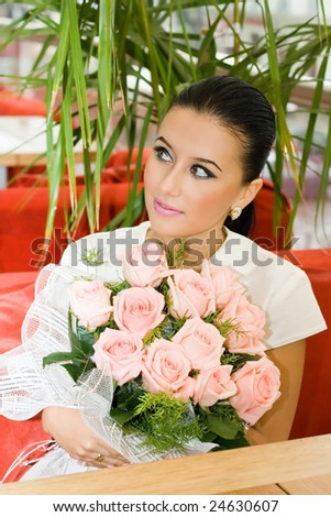 Pretty bride girl with flowers in cafe