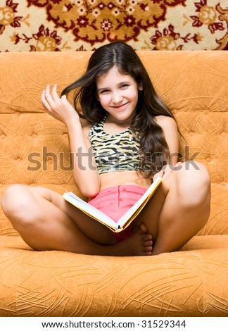 Teen girl read book on sofa