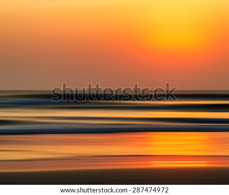 Horizontal vivid orange golden Indian ocean sunset motion abstraction background backdrop