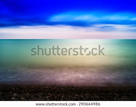 Horizontal dramatic ocean horizon on pebble beach landscape background backdrop