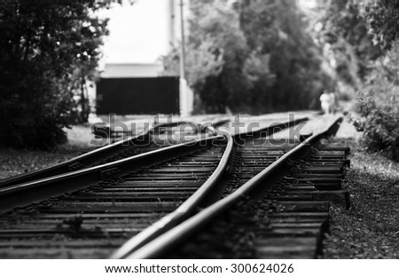 Horizontal black and white railroad track bokeh with people background