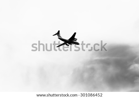 Horizontal black and white jet with sky background