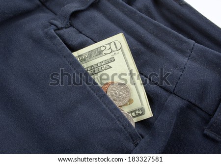 A twenty dollar bill sticking out the front pocket of dress jeans with coins
