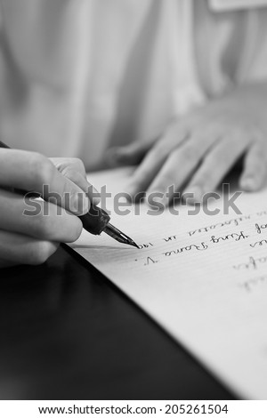 Retro effect faded and toned image of a girl writing a note with a fountain pen antique handwritten letter  page document poet journalist lawyer business plan study ccontract  letter pen memory report