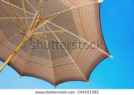 Thailand pattern silk umbrella and sky blue art artist  handicraft beach.