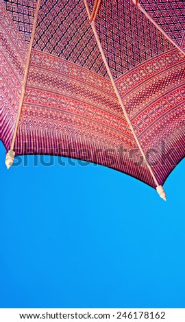 Thailand pattern silk umbrella and sky blue art artist handicraft beach.