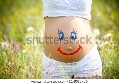 stock-photo-painted-happy-smiley-face-on-the-belly-of-pregnant-woman-114085786.jpg