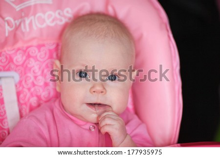 cheerful baby child eats itself with a spoon