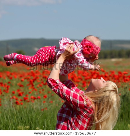 baby with his mother enjoying a field day outdoors.Mothers day holiday concept
