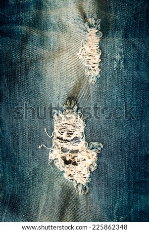 A closeup picture of a part of the jeans that is a bit torn