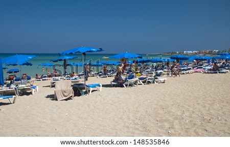 PROTARAS,CYPRUS-JULY 10,2013:Summer offer - an exotic destination,where to rest on the beach or to swim in cristal clear water of Mediterranean sea  in Protaras resort,Cyprus on july 10,2013