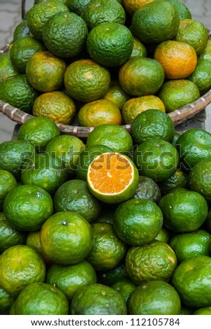 Two baskets of citrus for sale in an open market of South East Asia