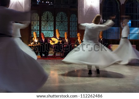 ISTANBUL - OCTOBER 21: Whirling dervishes and musicians perform to visitors in the event hall of Sirkeci Train Station, the old terminus of the Orient Express on October 21, 2005 in Istanbul, Turkey.