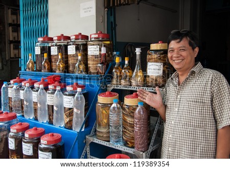 HO CHI MINH CITY - FEBRUARY 14: An unidentified man sells snake wine on February 14, 2007 in Ho Chi Minh City, Vietnam. Snake wine is a traditional beverage produced by infusing snakes in rice wine.