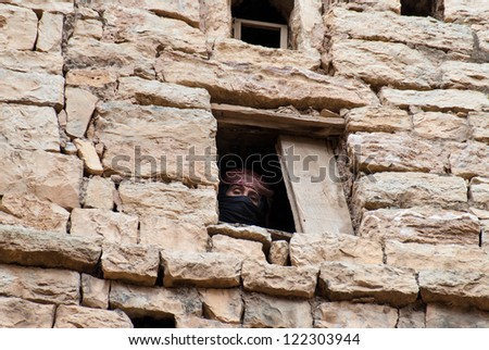 THULA, YEMEN - MAY 5: An unidentified woman looks through her window on May 5, 2007 in Thula, Yemen. Modern day women of Yemen do not hold many economic, social or cultural rights.