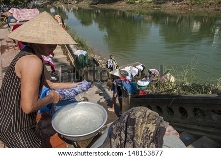 HUE, VIETNAM - JANUARY 12: A group of unidentified women do their laundry in the Perfume River on January 12, 2008 in Hue, Vietnam. The Perfume River is the artery of central Vietnam and Hue.