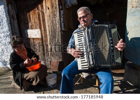 PRESPES LAKES, GREECE - DECEMBER 6, 2009: An unidentified old man plays his accordion in a village near the Prespes Lakes, an important Transnational Park divided between Albania, Greece and FYROM.
