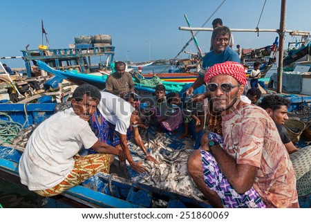 AL HUDAYDAH, YEMEN - MAY 12, 2007: Unidentified fishermen prepare fish for sale in the fish market of the city. Due to the rich Red Sea, fish markets play a central role in the economic life of Yemen.