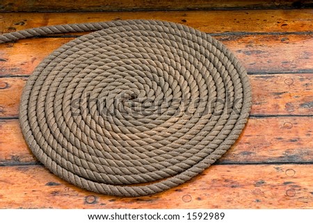 A rope coiled on the deck of a ship in Copenhagen, Denmark.