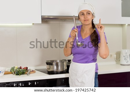 Cook tasting her food from a ladle standing with her finger raised thinking what ingredient is missing that she still needs to add