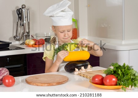 Serious Kid Chef Piling Fresh Vegetable on White Wooden Table