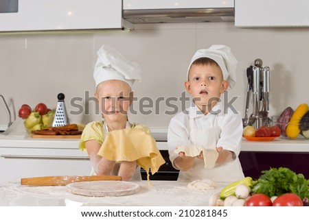 Adorable White Kids in Chefs Attire Making Foods for Snacks at the Kitchen.