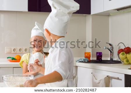Very Happy Little Chefs Baking Something to Eat in the Kitchen.