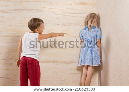Cute Little Brother Laughing To His Sister Facing on Wooden Walls