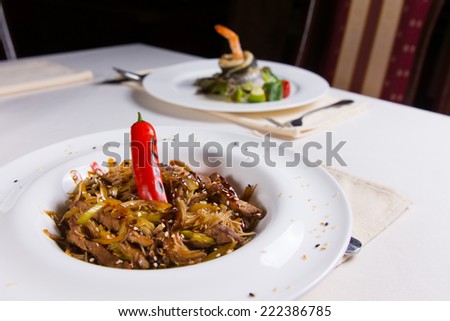 Stir Fried Noodles in Bowl with Hot Pepper on Restaurant Table