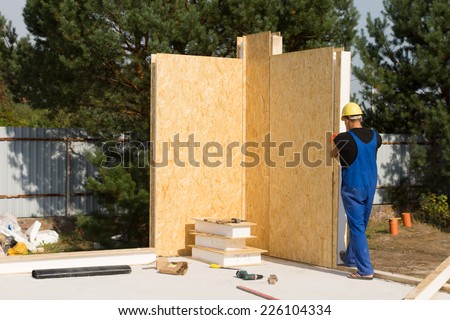 Male Construction Worker Building a Real Estate House Wall Alone.