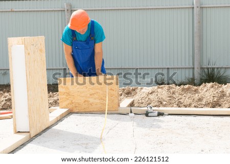 Solo Busy Male Construction Worker with Orange Helmet Building Real Estate House Wall.
