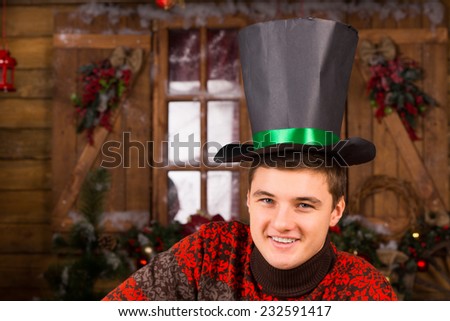 Close up Handsome Smiling Young Man with Black Hat, Looking at the Camera, In front Wooden Wall and Glass Window with Christmas Decors.