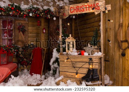 Lighted Wooden Christmas Booth Inside a House with Various Christmas Decorations.