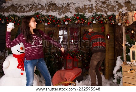 Young Partners in Trendy Winter Outfit Playing with Cotton Snow Inside the House with Many Christmas Decorations.